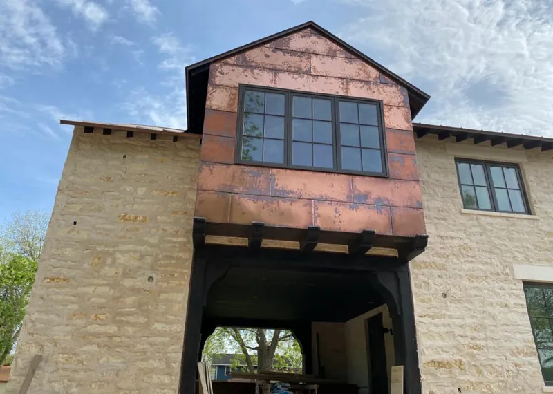 Copper metal panel facade on a stone building for Skylight Installation in St. Louis Park